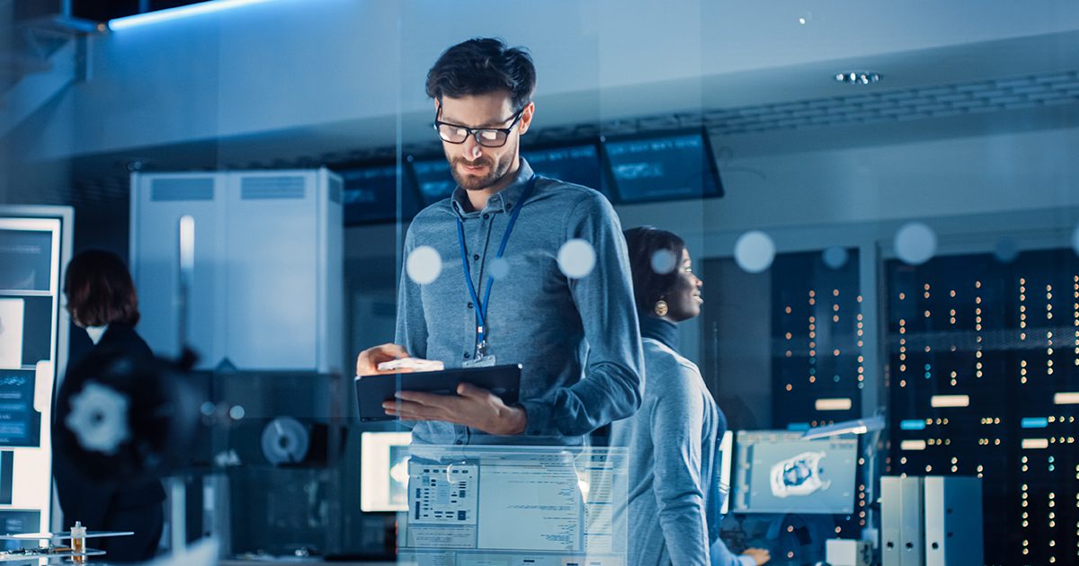 IT Professionals in server room looking at tablet