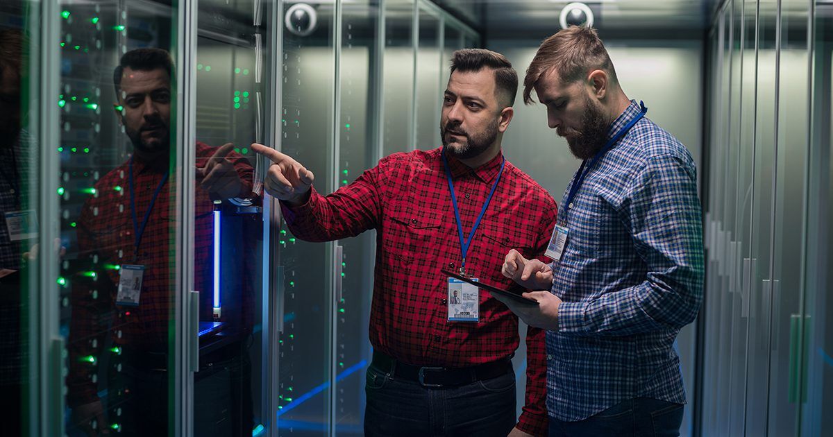 IT Professionals in server room looking at tablet