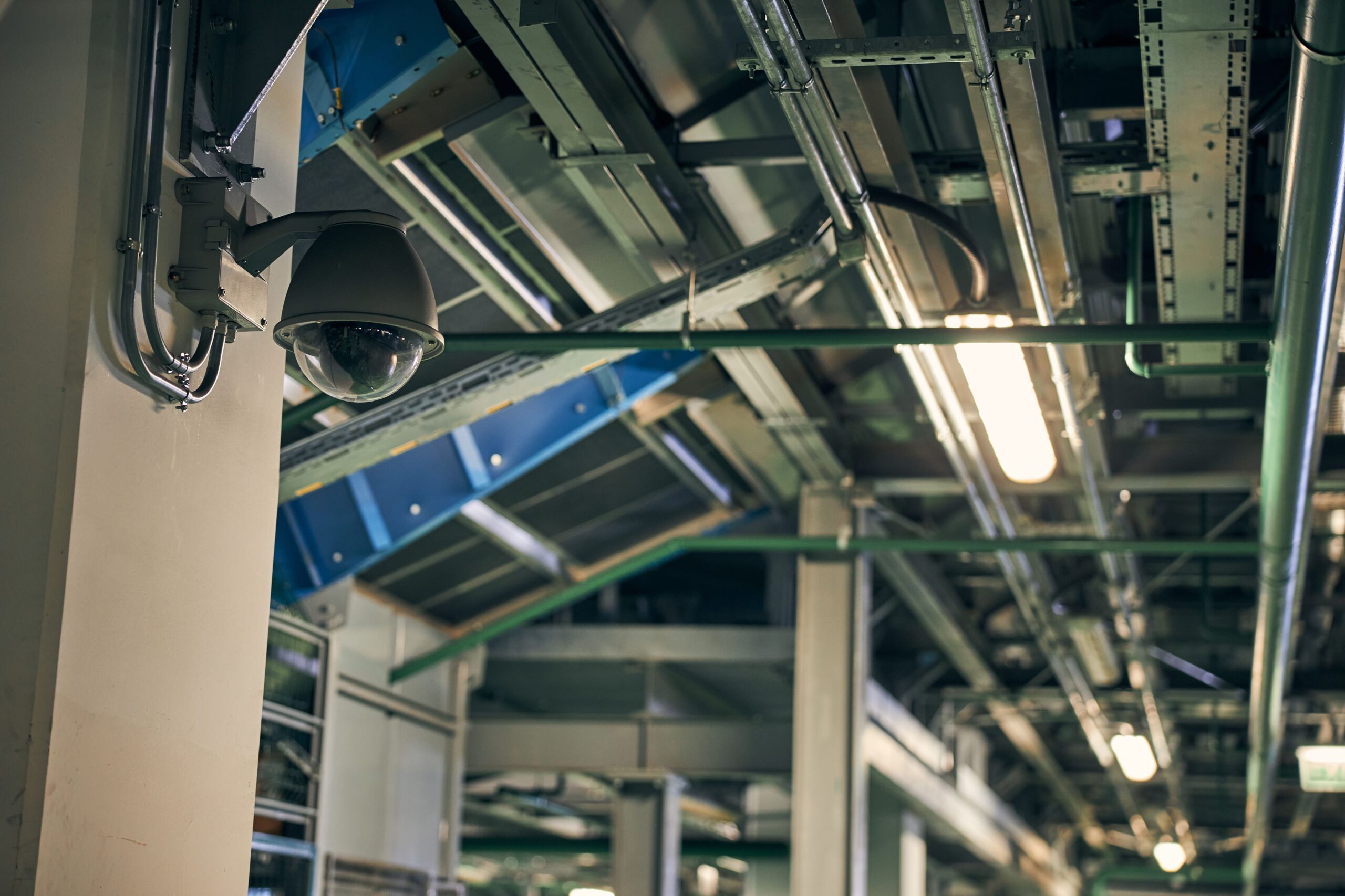 Security surveillance camera on a wall of a building