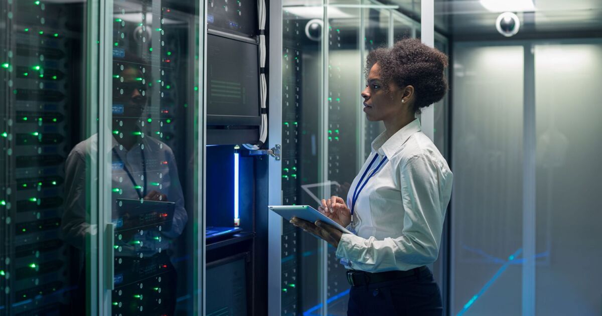 female technician working on tablet in data center