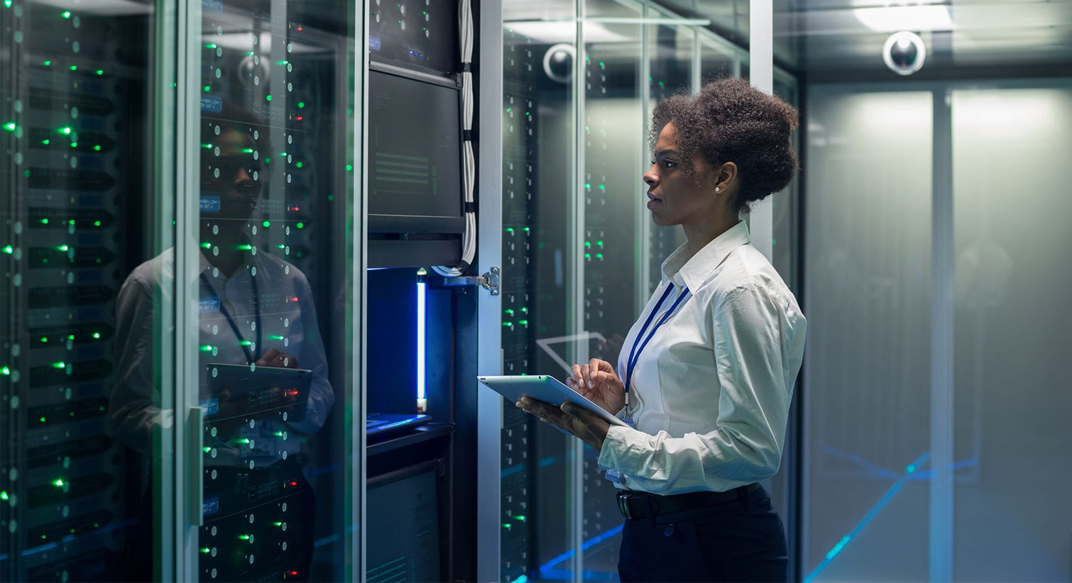 female technician working on tablet in data center