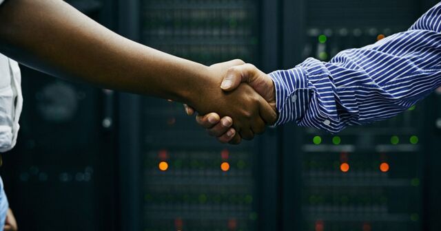 IT services professionals shake hands