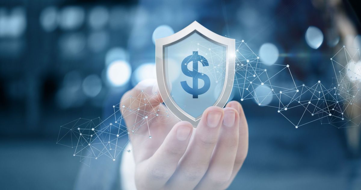 Businessman shows a shield with dollar sign .