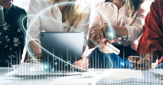 group of people working together on a tablet