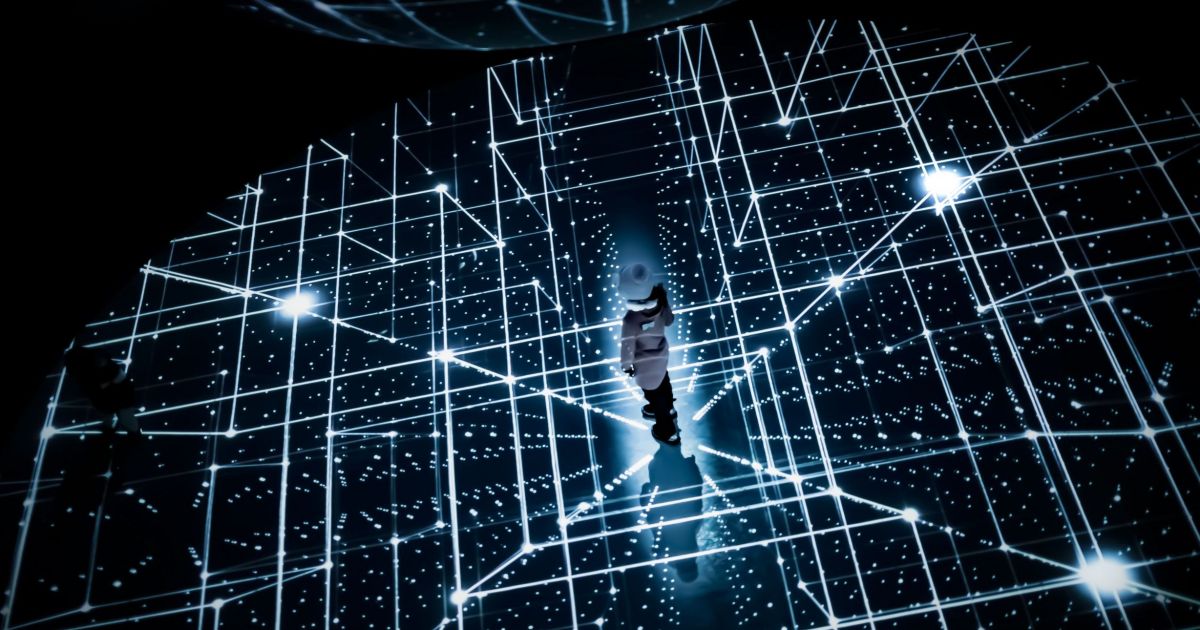 Person standing in the middle of a virtual grid, symbolizing innovation.