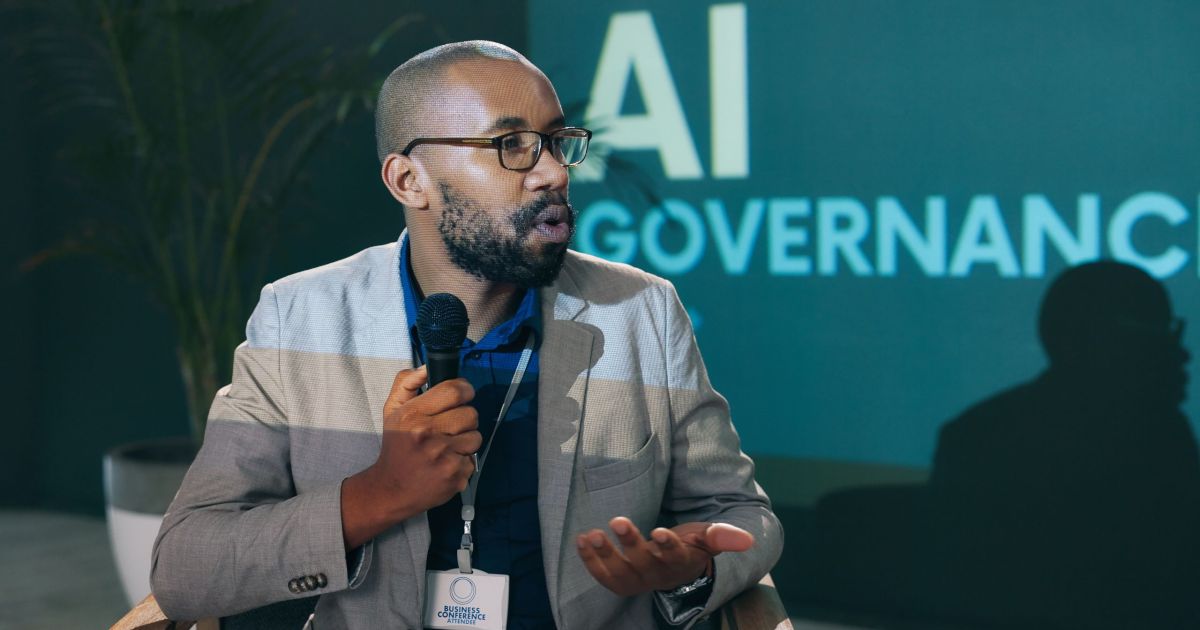 Man speaking at conference about AI governance