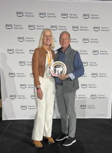 Two Presidio employees posing with the presidio AWS Marketplace Partner of the year award