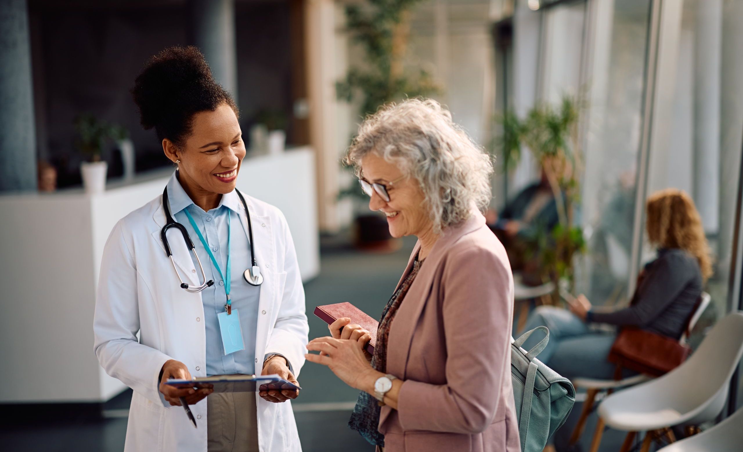 Patient and doctor talking about healthcare with Ipad