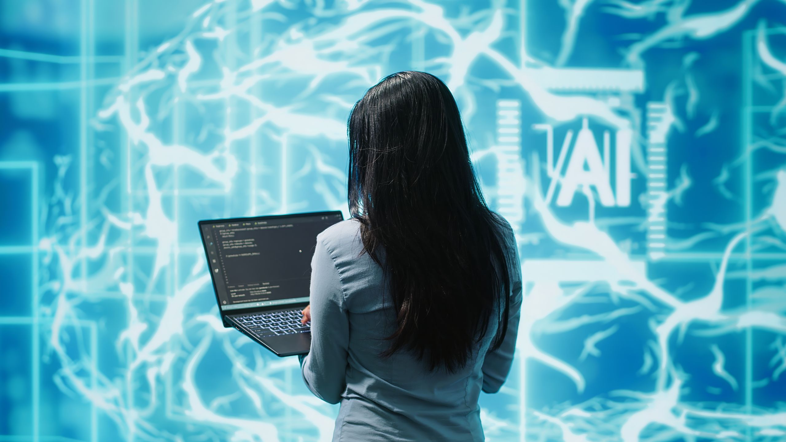 Business woman working on laptop, programming artificial intelligence computing simulating human brain. Woman using notebook, developing AI machine learning algorithms, camera A