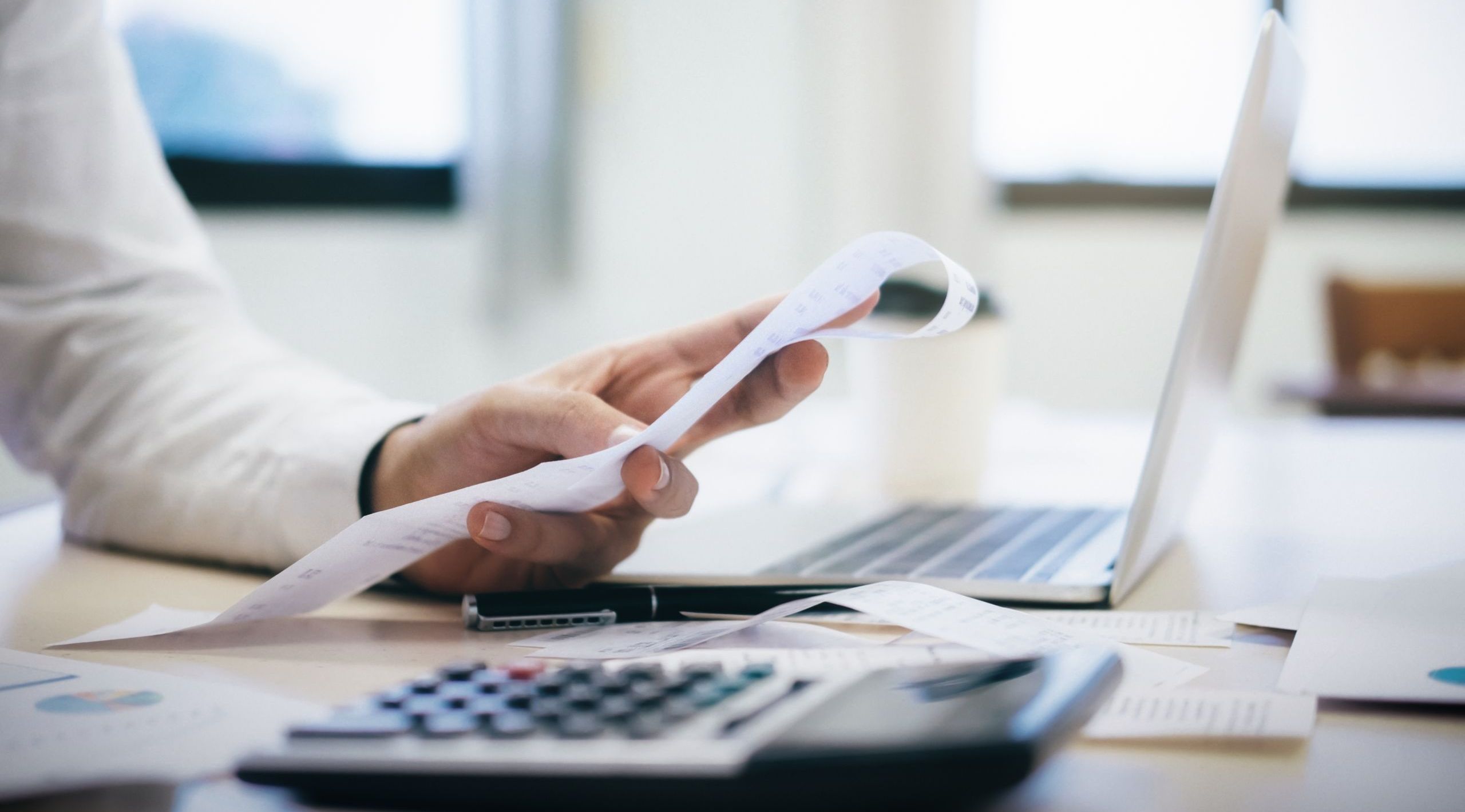 Male accountant or banker calculate the cash bill.