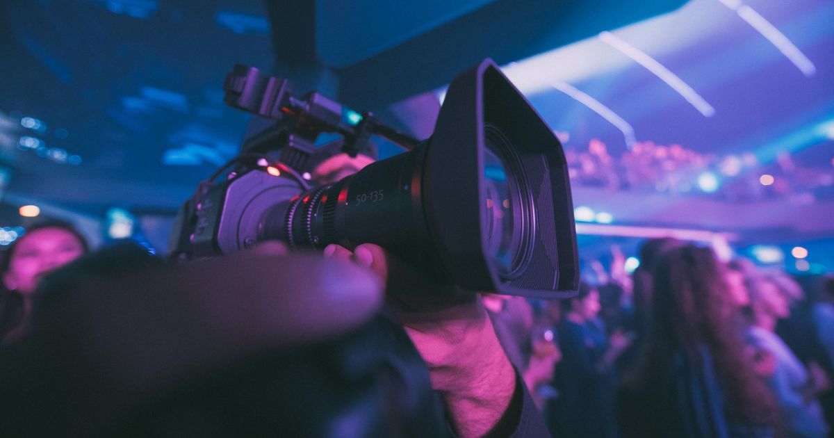 sports broadcaster filming an event with a camera
