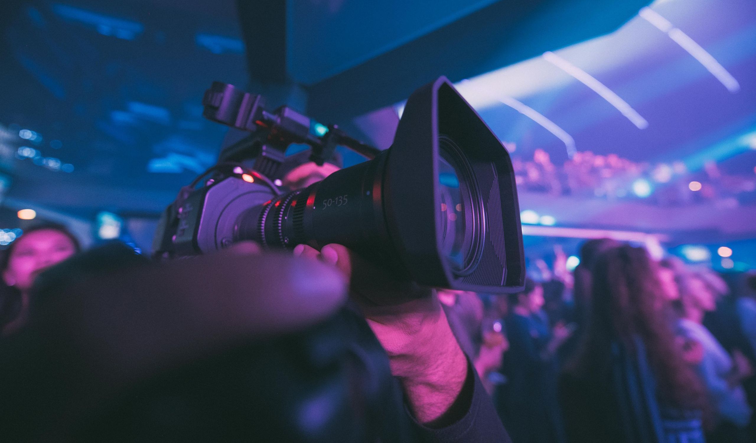 sports broadcaster filming an event with a camera