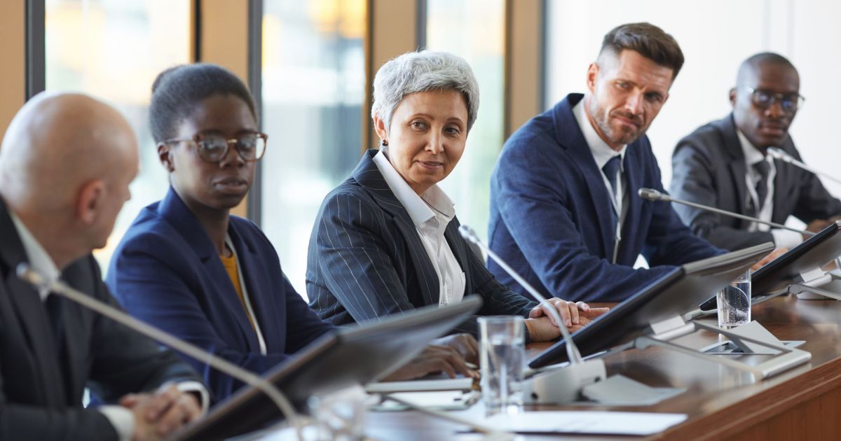 Group of business people discussing new project together in team during meeting at board room