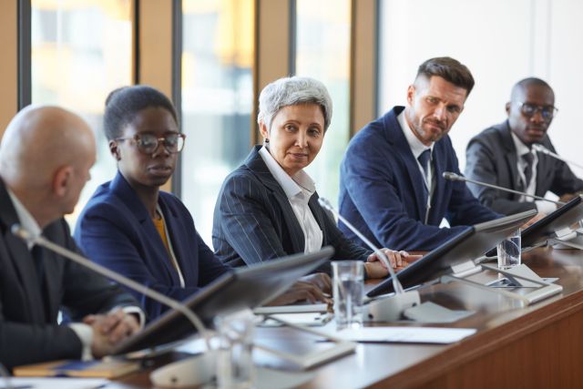 Group of business people discussing new project together in team during meeting at board room