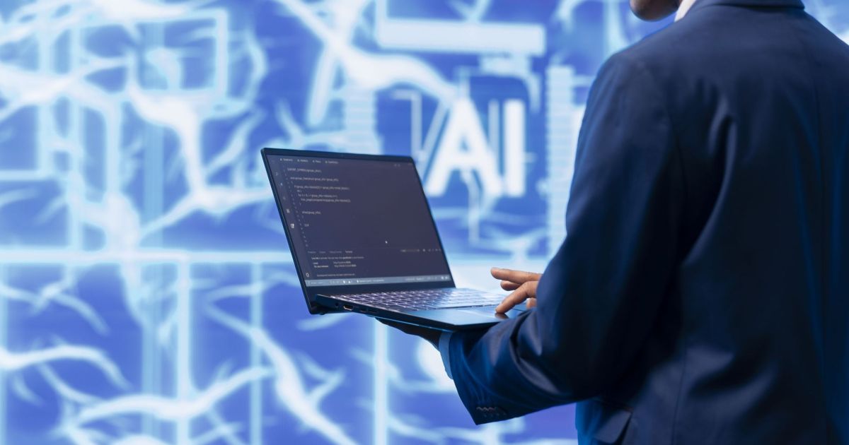 Technician writing code for AI applications development on notebook